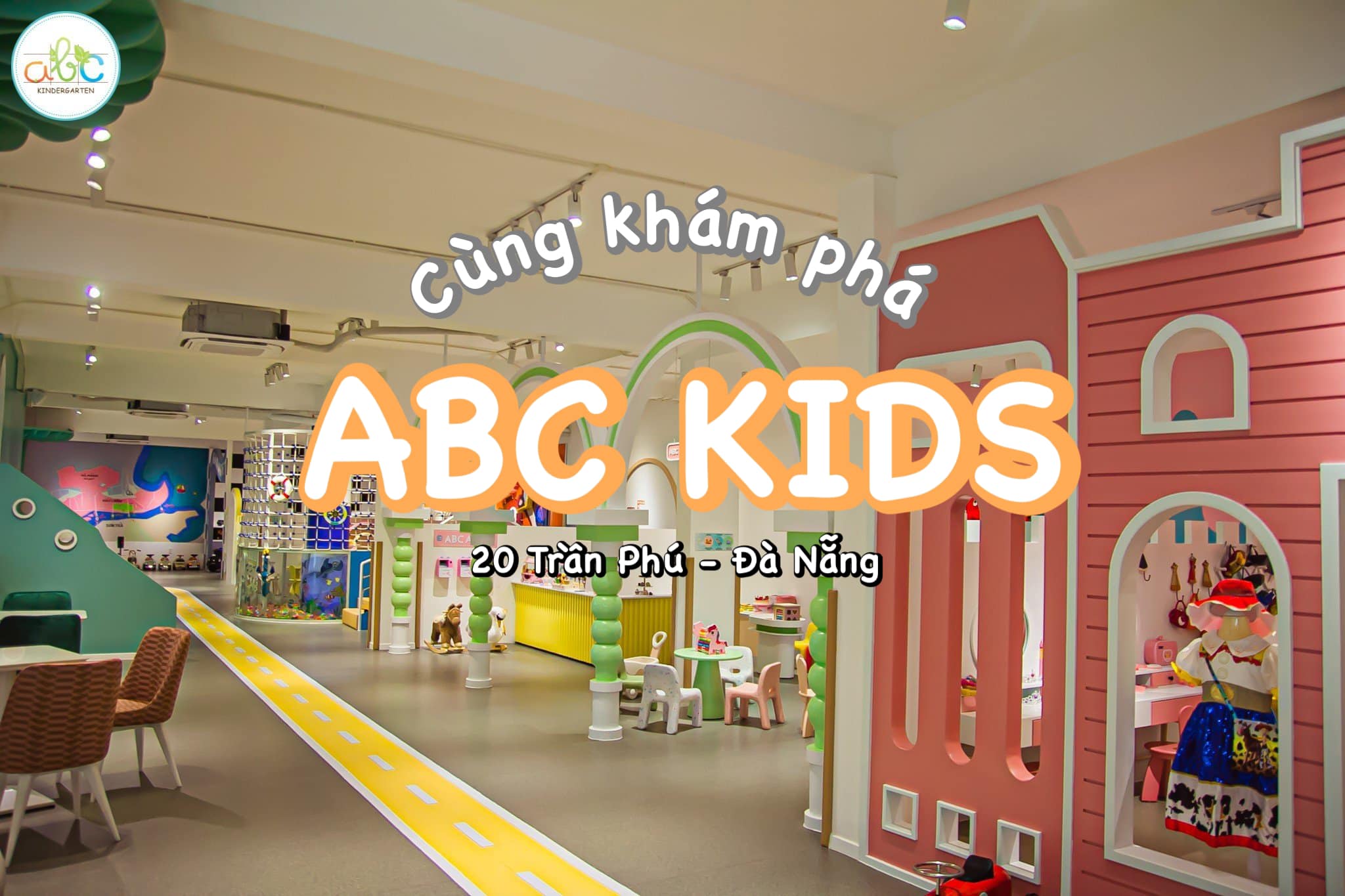 Khu vui chơi trong nhà tông pastel với biển 'ABC KIDS' và lối đi mô phỏng đường